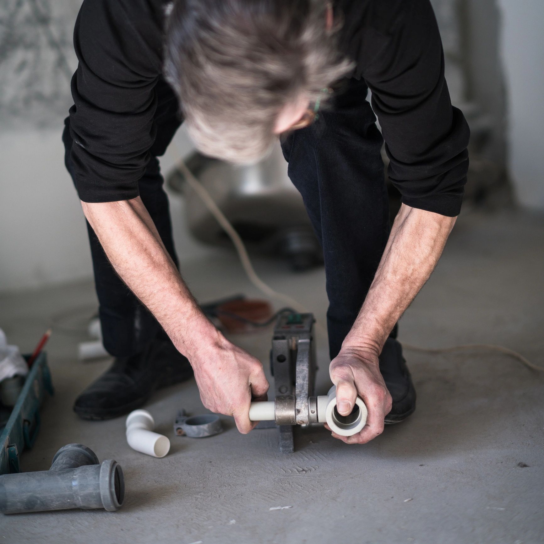 Plumber working on residential pipe connections